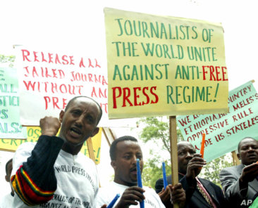 Ethiopian journalists hold placards as they shout slogans during a demonstration at the Ethiopian Embassy in Nairobi, Tuesday, May 2, 2006. A group of journalists demanded the release of more than a dozen jailed colleagues in Ethiopia who were arrested during a crackdown on the press earlier this year on charges of treason and genocide, which are punishable by death. (AP Photo/Sayyid Azim)