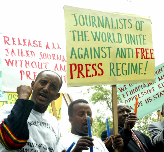 Ethiopian journalists hold placards as they shout slogans during a demonstration at the Ethiopian Embassy in Nairobi, Tuesday, May 2, 2006. A group of journalists demanded the release of more than a dozen jailed colleagues in Ethiopia who were arrested during a crackdown on the press earlier this year on charges of treason and genocide, which are punishable by death. (AP Photo/Sayyid Azim)
