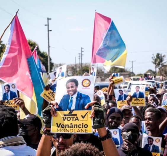 A poster of independent candidate Venacio Mondlane is held at an election rally on Sunday, Oct. 6, 2024 in Maputo ahead of elections in Mozambique. (AP Photo/Carlos Uqueio)